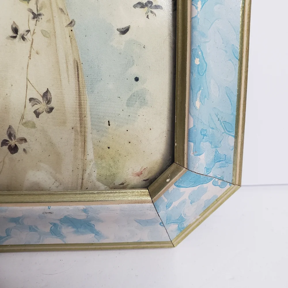 Vintage-style framed print of a young girl adorned with flowers.  228